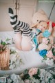 A woman laying on a bed with a teddy bear.