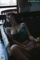 A woman sitting on a couch with her eyes closed.