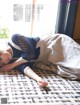 A woman laying on the floor in front of a window.