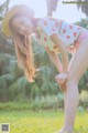 A woman in a straw hat is posing for a picture.