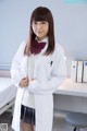 A woman in a white lab coat and a red bow tie.